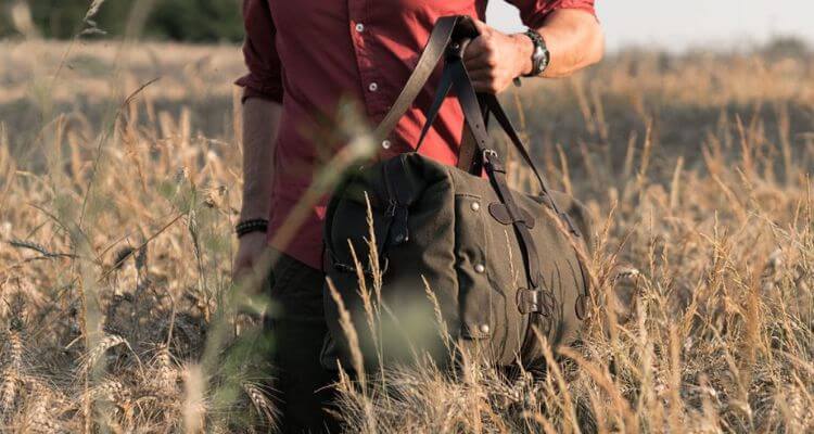 Adventurous Journey - Man exploring with a canvas duffle bag, ready for exciting travels and outdoor escapades.