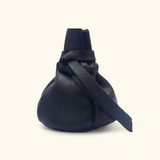 Compact black leather pouch tied with drawstrings, ideal for organizing valuables.