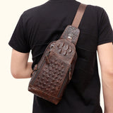 Back view of a model wearing the Croc Ridge Leather Sling Bag - Claw Style, highlighting the detailed crocodile pattern on rich brown leather.