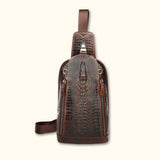 Front view of the Croc Ridge Leather Sling Bag - Gator Style, showcasing the intricate crocodile pattern on rich brown leather with dual zipper compartments.