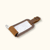 A suitcase tag made of durable leather, designed to withstand travel wear and tear while adding a touch of elegance to your luggage.