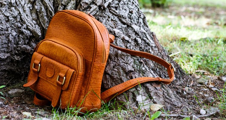 Western-inspired leather sling bag featuring intricate detailing and adjustable strap.