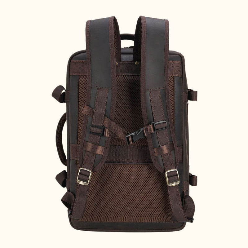 The Stetson Peak - Expandable Men's Leather Backpack in dark brown, back view showcasing padded shoulder straps, secure buckles, and a comfortable mesh back panel for ergonomic support.