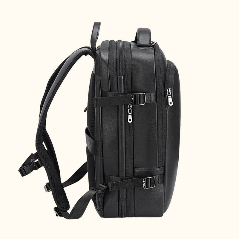 The Stetson Peak - Expandable Men's Leather Backpack in black, side view highlighting the adjustable straps, sturdy buckles, and spacious compartments.