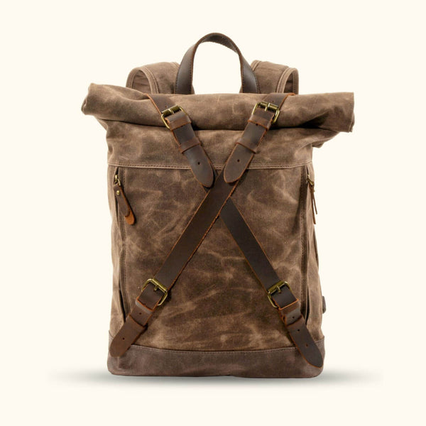 Brown Waxed Canvas Rucksack - Embrace timeless style and durability with this brown waxed canvas rucksack. Designed to withstand the demands of your daily adventures, it features a rugged yet refined look, ample storage space, and adjustable straps for a comfortable fit. From city streets to rugged trails, this rucksack is the perfect companion for the modern explorer.