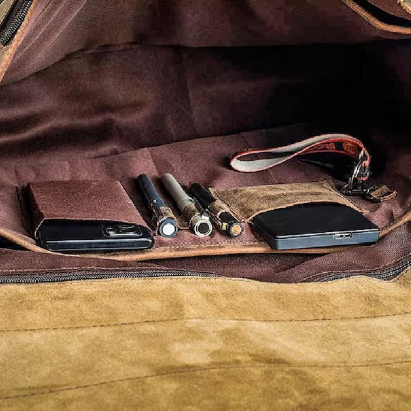 "Interior view showcasing phone pockets, notepad holder, three pen holders, zipper pockets, and key chain holder, adding convenience and organization to the Saloon Full-Grain Leather Briefcase.