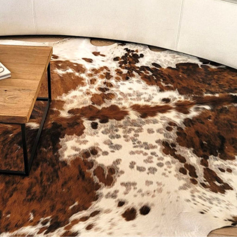 Cowhide rug adding rustic charm to a modern living room decor.