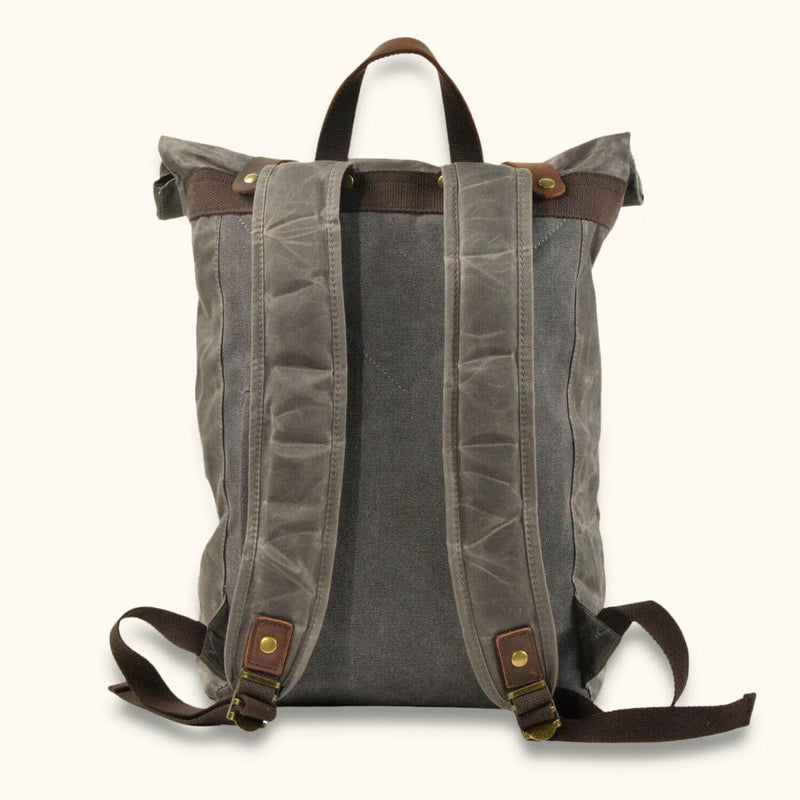 Roll-Top Backpack - Waxed Canvas - Discover the rugged charm of our roll-top backpack crafted with waxed canvas. This versatile backpack features a spacious main compartment, adjustable straps, and a secure roll-top closure. It's designed to withstand the elements and offers reliable functionality for everyday use, outdoor adventures, and travel. Embrace the timeless appeal of waxed canvas with this durable and stylish roll-top backpack.
