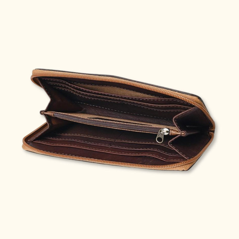 Interior view of a Western-style hair-on cowhide zip clutch showing ample compartments for cards and cash.