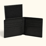 Open interior of The Ashford black crocodile bifold wallet with the ID flap raised, six card slots, premium full-grain calf leather, and an embossed RIVER logo.