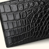 Close-up of The Ashford premium black crocodile bifold wallet, highlighting the genuine Siamese crocodile scale texture, fine stitching, and handcrafted leather finish.