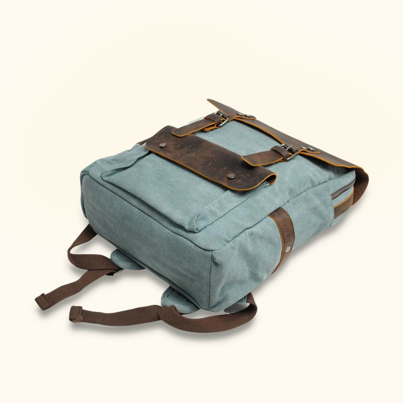 Blue Waxed Canvas Laptop Backpack - Infuse your style with a touch of resilience, as this blue waxed canvas backpack ensures the safety and convenience of carrying your laptop and essentials.