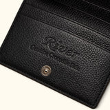 Interior detail of The Compact Crocodile Wallet in black showing River branding and full-grain leather