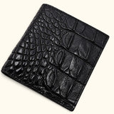Close-up of The Compact Crocodile Wallet in black showing natural crocodile scales, fine grain and detailed stitching