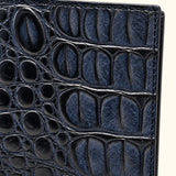 Close-up of Deep Navy crocodile leather showing natural scale texture, fine grain and detailed stitching