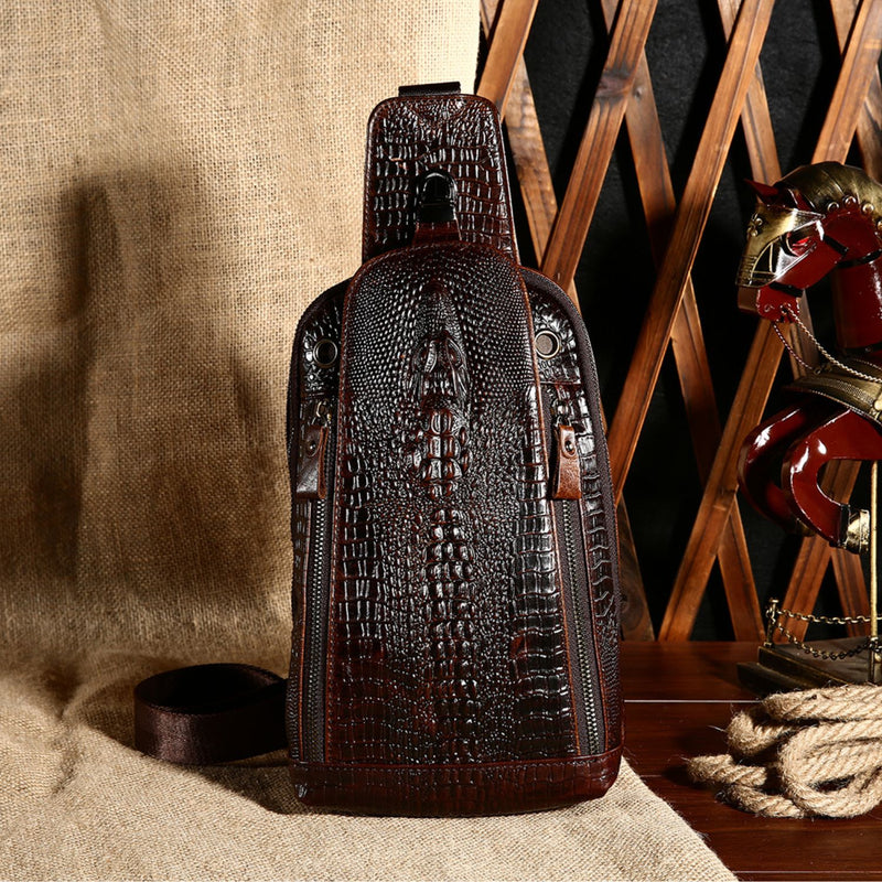 Display view of the Croc Ridge Leather Sling Bag - Gator Style, showcasing the intricate crocodile pattern on rich brown leather set against a rustic background.