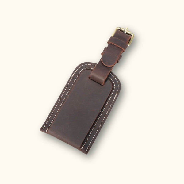 Close-up of a dark brown leather tag, featuring intricate stitching and a rich, luxurious texture.