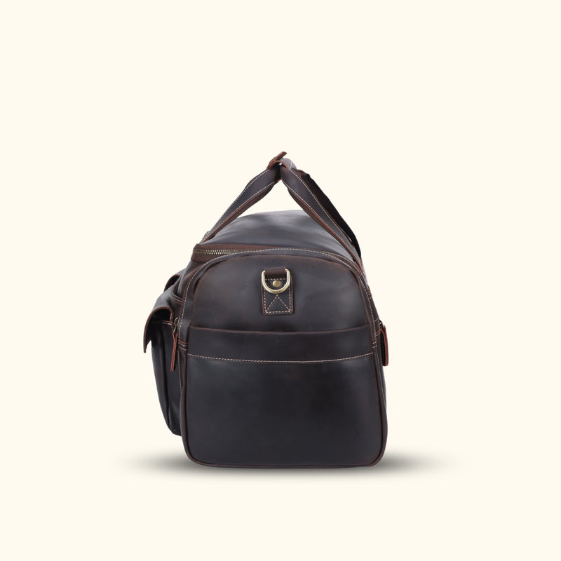 Stylish dark brown leather weekender bag, perfect for short trips or weekend getaways, featuring a sleek design and durable construction to keep your essentials organized and secure in timeless elegance.
