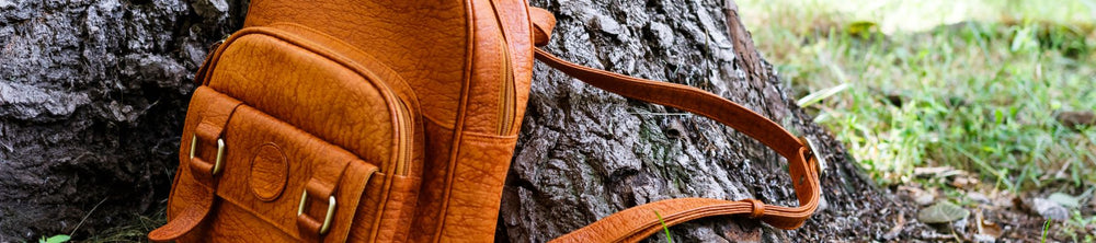 Western-style leather sling bag with intricate stitching and adjustable strap
