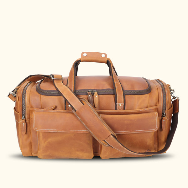 Stylish light brown leather duffle bag, perfect for travel or everyday use, featuring sturdy straps and ample storage space.