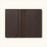 Open brown interior of The Rancher's Legacy full-grain leather cardholder showing slim card pockets, embossed Western Leather Goods branding, precise stitching, and textured center lining.