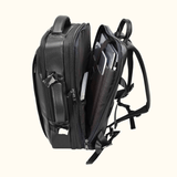 The Stetson Peak - Expandable Men's Leather Backpack in black, open view showing multiple spacious compartments, internal pockets, and secure buckles for organized storage.