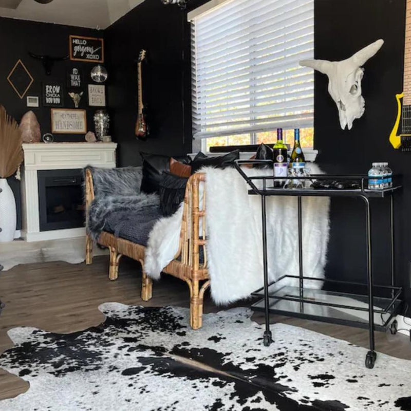 Texas Range Black and White Cowhide Rug in a stylish living room setting.