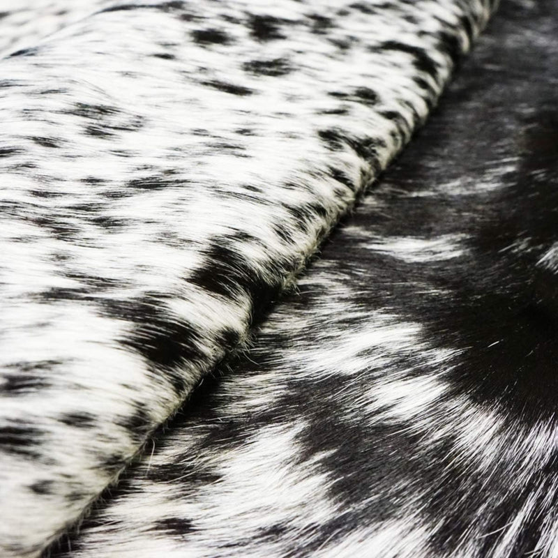 Folded Texas Range Black and White Cowhide Rug showcasing detailed texture.