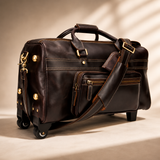 Three quarter angle view of The Lawful Leather Duffle with Wheels featuring premium full grain leather, detachable padded shoulder strap, front organizer pocket, brass hardware, and smooth rolling spinner wheels.