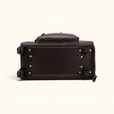 The Lawful Leather Duffle with Wheels bottom view featuring a reinforced leather base, smooth rolling wheels, protective hardware, and durable construction for long lasting travel performance.