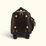 The Lawful Leather Duffle with Wheels side view featuring premium full grain leather, reinforced side panel, durable brass hardware, smooth rolling wheels, and a telescoping handle system.