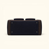 Bottom view of The Weekender navy waxed canvas and leather duffel featuring reinforced leather corners and protective metal feet.