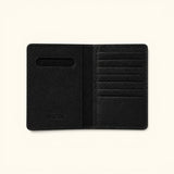 The Western Traveler black leather passport holder, open interior view showing multiple card slots, passport pocket, and Western Leather Goods embossing.