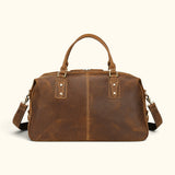 Back view of The Wolf men’s full-grain leather travel duffel with detachable shoulder strap, reinforced handles, and vintage brown finish.