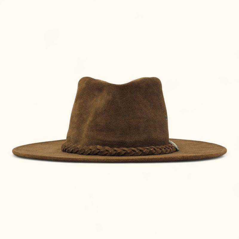 Front view of The Trailsman – a brown suede Western hat with a wide flat brim, eyelets on the crown, and a braided leather band with a metal concho.