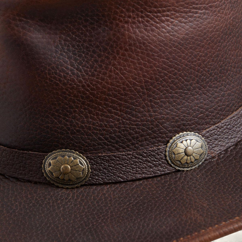 Close-up of the Walker leather hat showing full-grain leather texture and antique concho band
