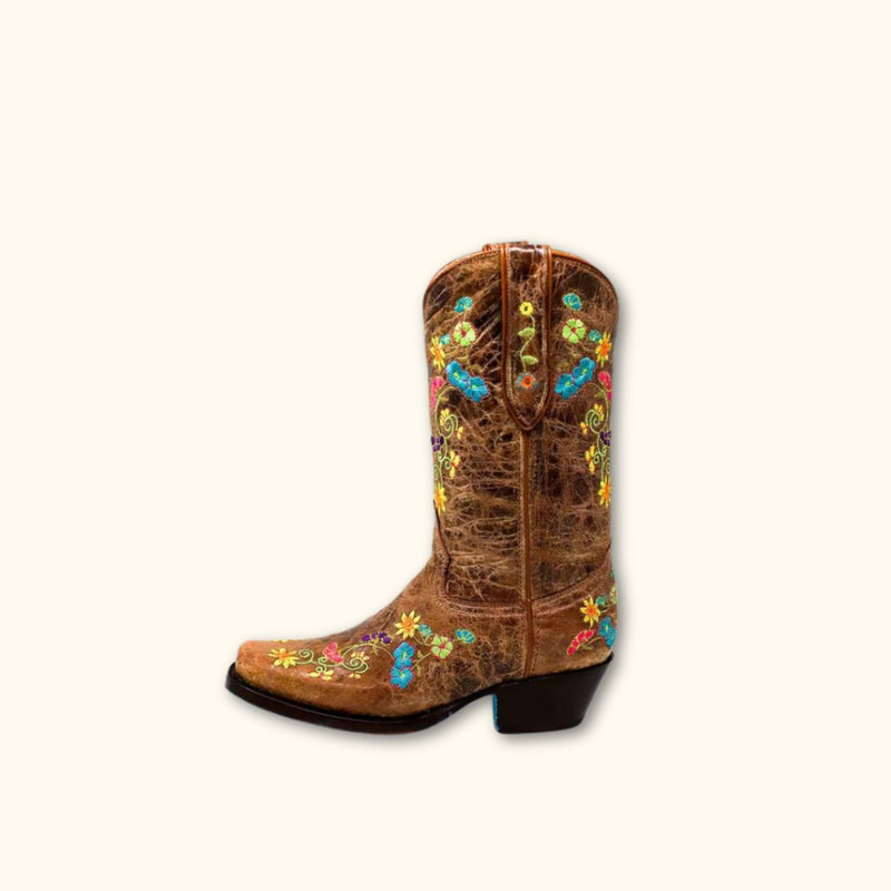 Side view of Wildflower Bliss Leather Cowgirl Boots displaying colorful embroidery and rustic leather finish.

